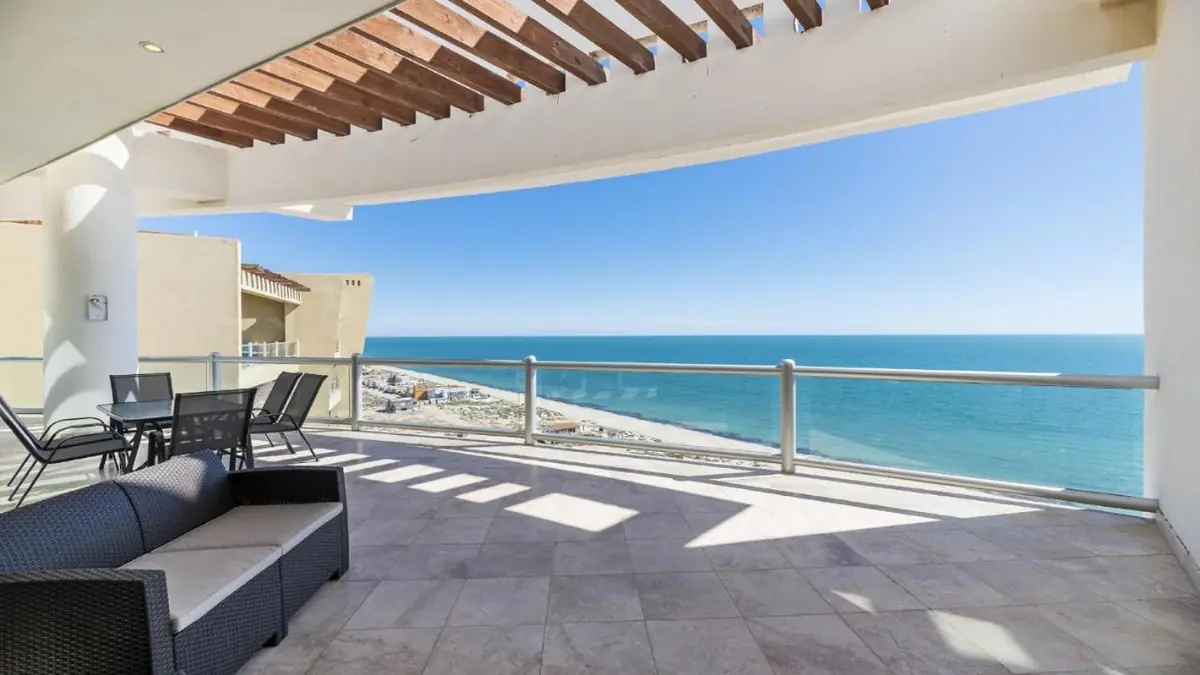 Penthouse terrace with armchairs and a table, overlooking the Sea of Cortez